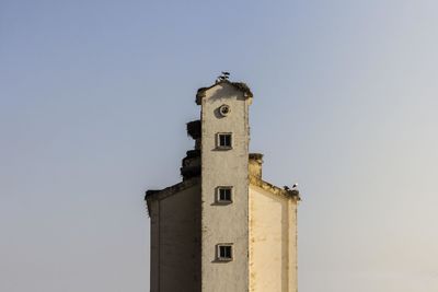 High section of built structure against clear blue sky