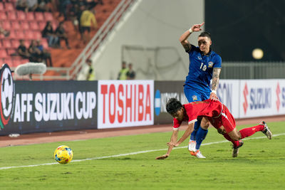 Full length of man standing on soccer field