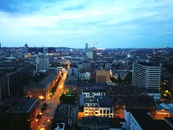 High angle view of illuminated city buildings against sky