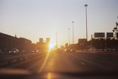 Traffic on road at sunset