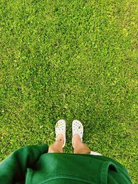 Low section of woman standing on field