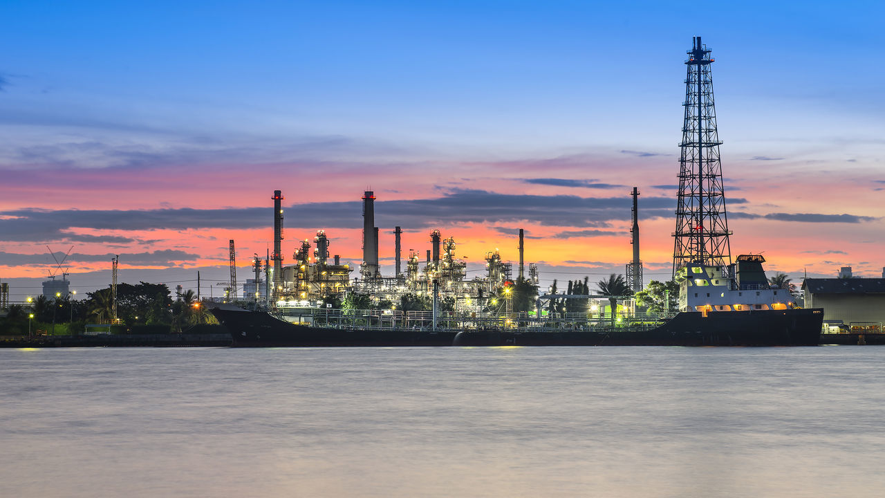 FACTORY AGAINST CLOUDY SKY DURING SUNSET