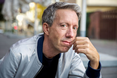 Portrait of man sitting outdoors