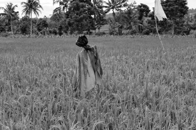 Rear view of a woman walking on field