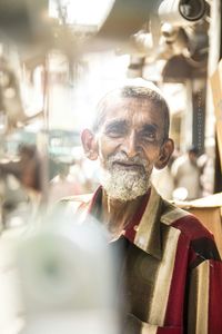 Portrait of senior beard man in city