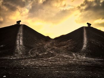 Low angle view of silhouette land against sky during sunset