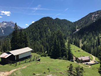 Scenic view of trees and buildings against sky