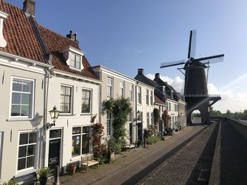 Street amidst buildings in city against sky