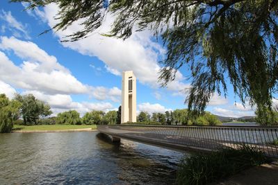 Bridge over lake burley griffin against tower