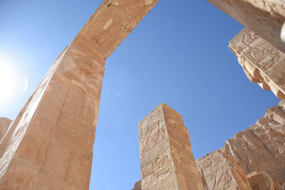 Low angle view of old ruins against blue sky