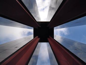 Low angle view of modern building against cloudy sky