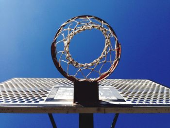 Low angle view of basketball hoop against blue sky