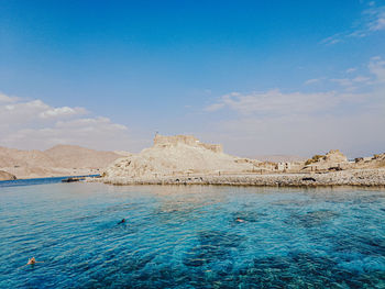 Scenic view of sea against blue sky