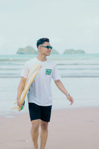 Portrait of man standing at beach