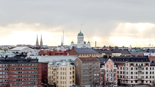 Cityscape against cloudy sky