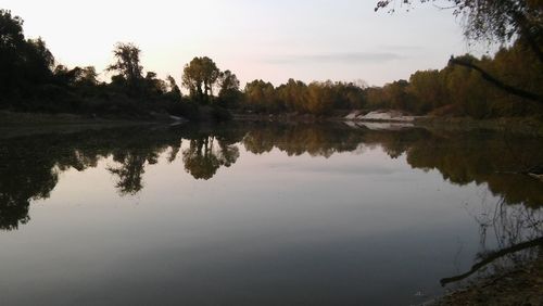 Scenic view of lake against sky at sunset