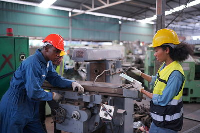 Rear view of man working in factory