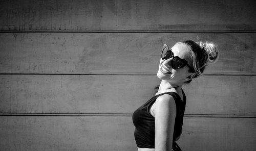Portrait of woman standing against wall