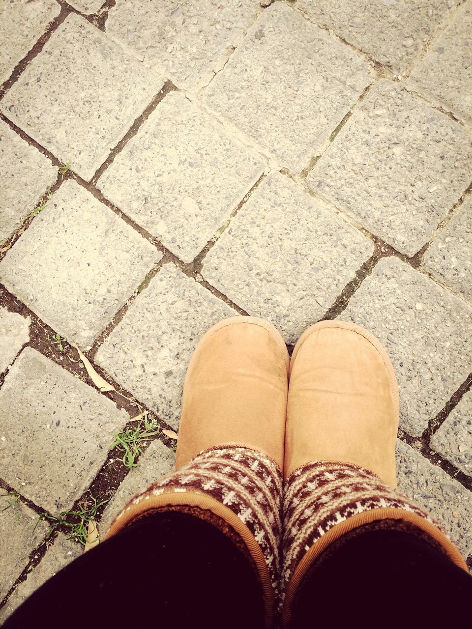 low section, person, shoe, high angle view, cobblestone, personal perspective, pattern, close-up, street, directly above, paving stone, textured, standing, footpath, footwear, outdoors, part of