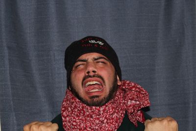 Close-up of man screaming against textile