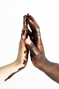 Close-up of hand over white background