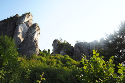 Low angle view of rocks against clear sky