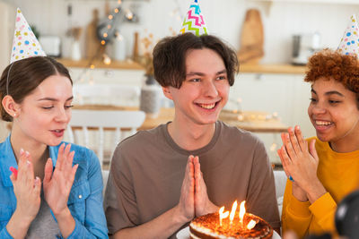 Portrait of smiling young woman holding christmas cake