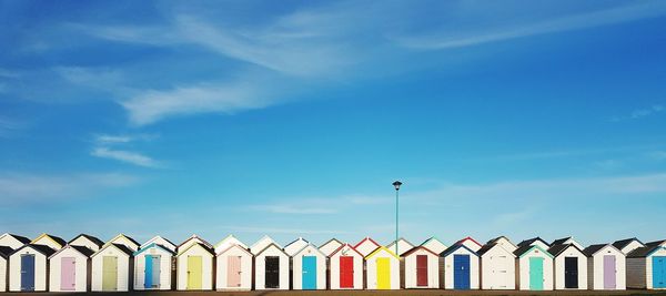 Low angle view of beach huts against sky