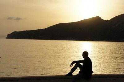 Silhouette of people looking at sunset