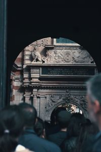 Rear view of people walking in historical building