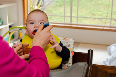 Portrait of boy sitting at home