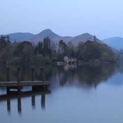 Scenic view of lake and mountains against clear sky