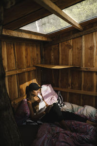 Woman in hut reading book