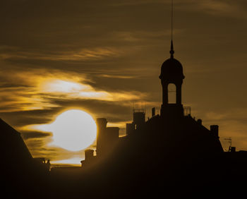 Silhouette cathedral against sky during sunset