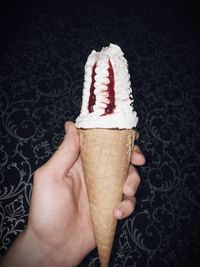 Midsection of person holding ice cream cone