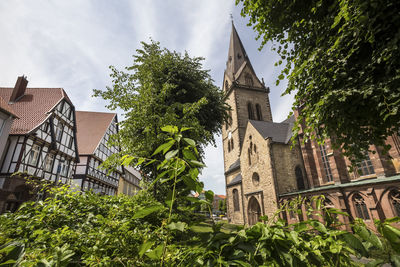 Low angle view of built structure against trees