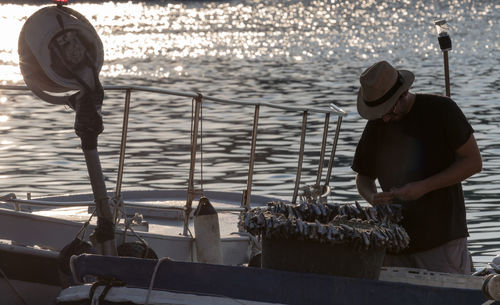 Man working on boat in sea 