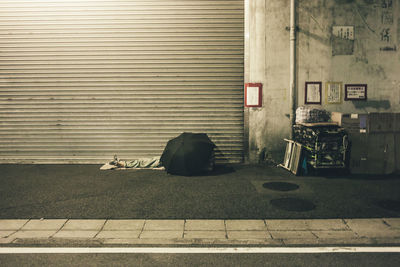 Garbage on street against building