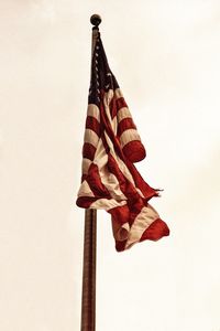 Low angle view of flag hanging against clear sky