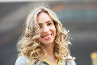 Portrait of smiling young woman in city