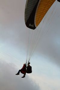 Tourists paragliding in sky