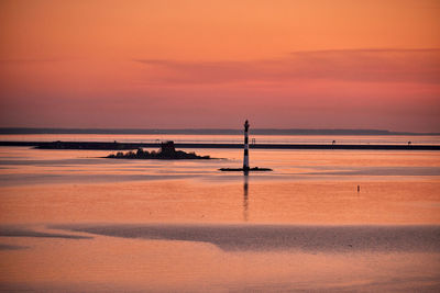 Scenic view of sea against orange sky