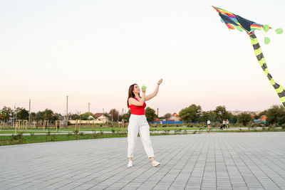 Active lifestyle. happiness concept. happy young woman running with a kite in a park at sunset