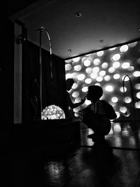 Man sitting in illuminated building