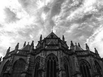 Low angle view of building against cloudy sky