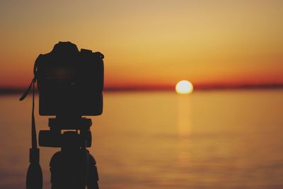 Scenic view of sea against orange sky during sunset