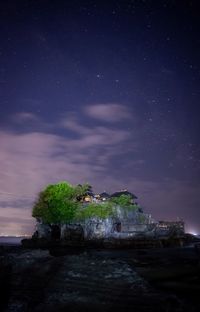 Scenic view of sea against sky at night. tanah lot, bali indonesia