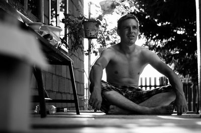Portrait of young man sitting outdoors