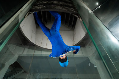 Low section of man standing on escalator