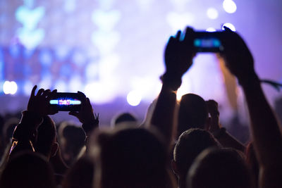 People photographing at music concert